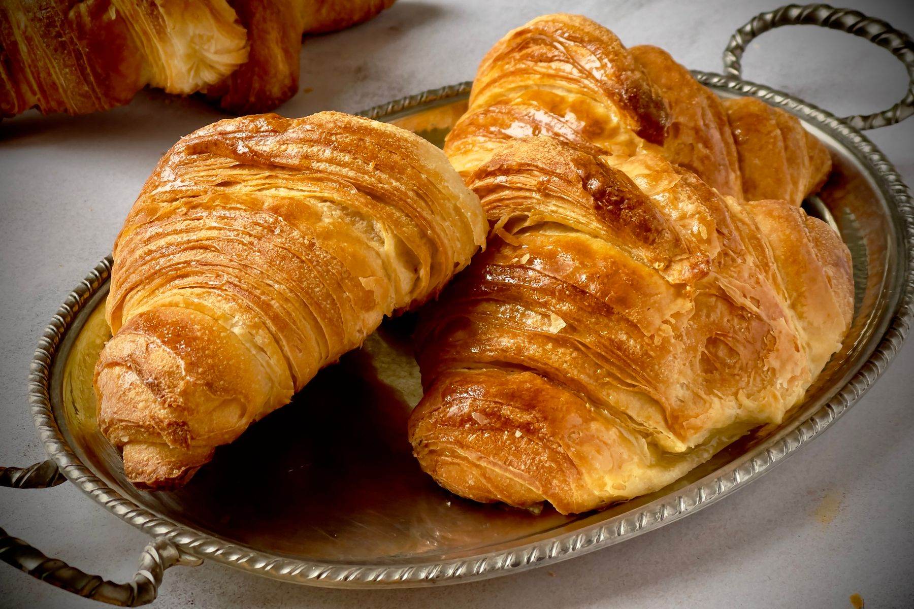 Croissants on a plate by the window.