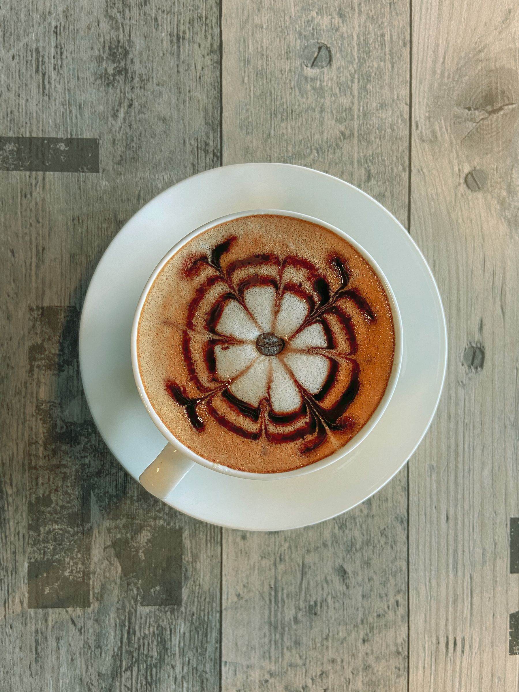 A milky coffee on the counter.