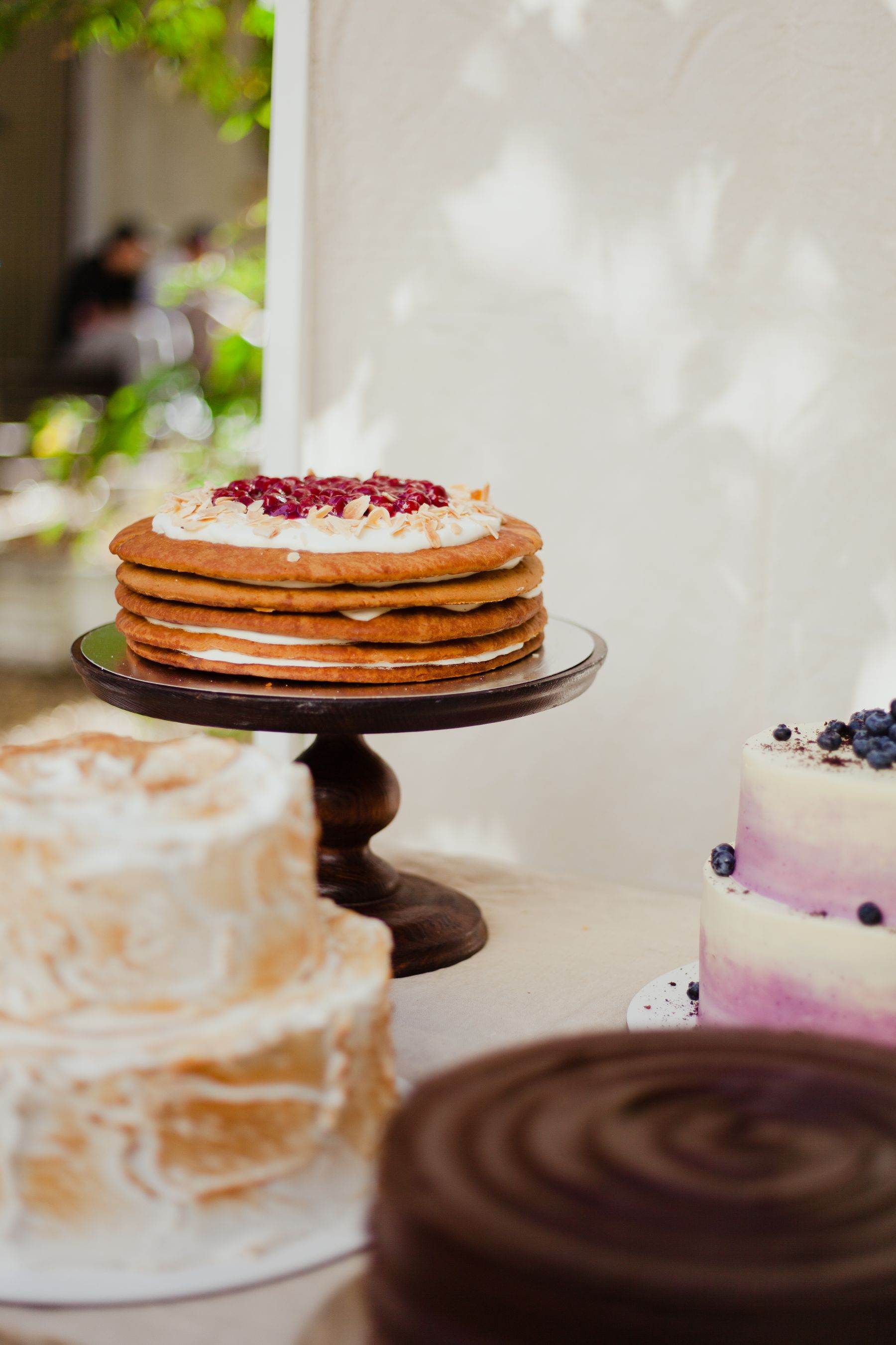 A tall celebration cake on a stand.